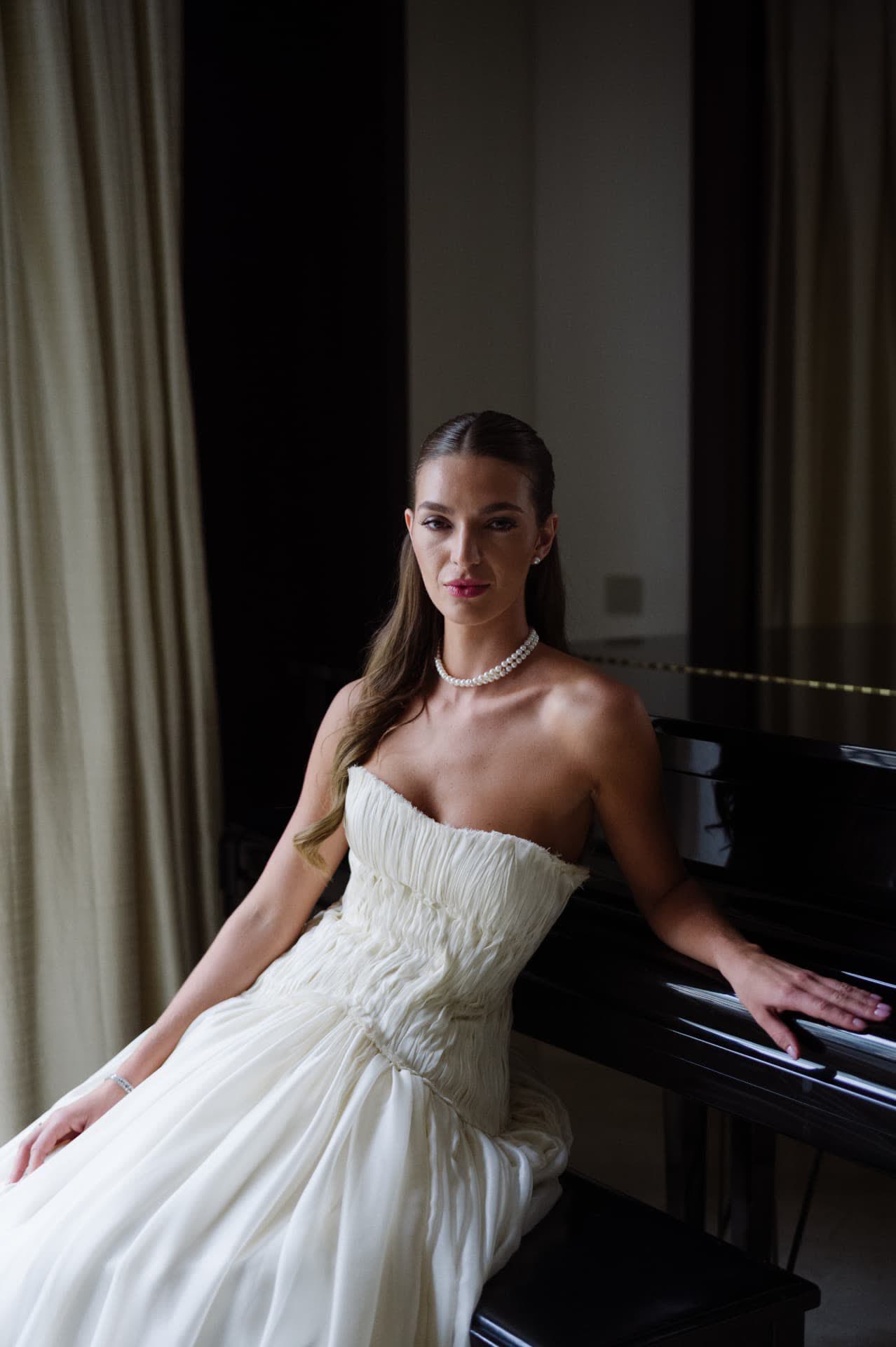 Bride seated by a grand piano
